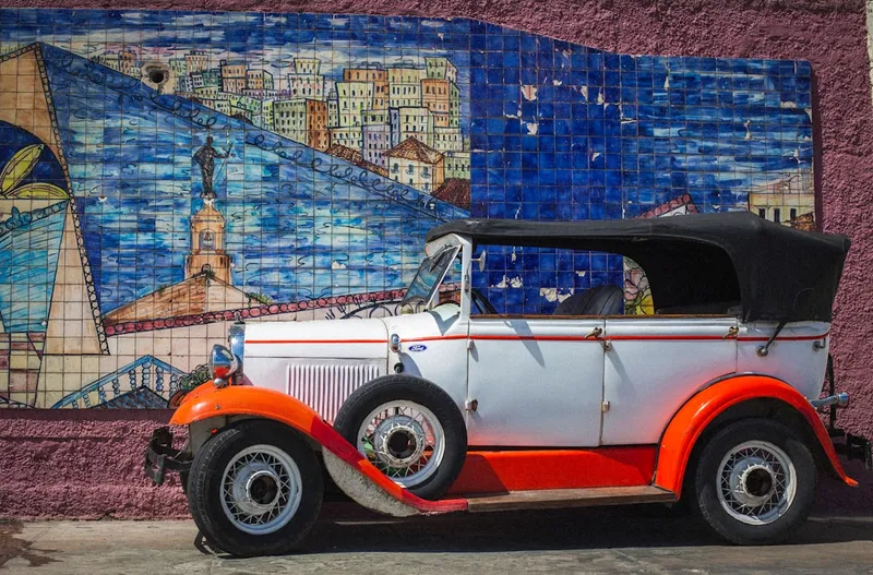 an orange and white car parked in front of a building